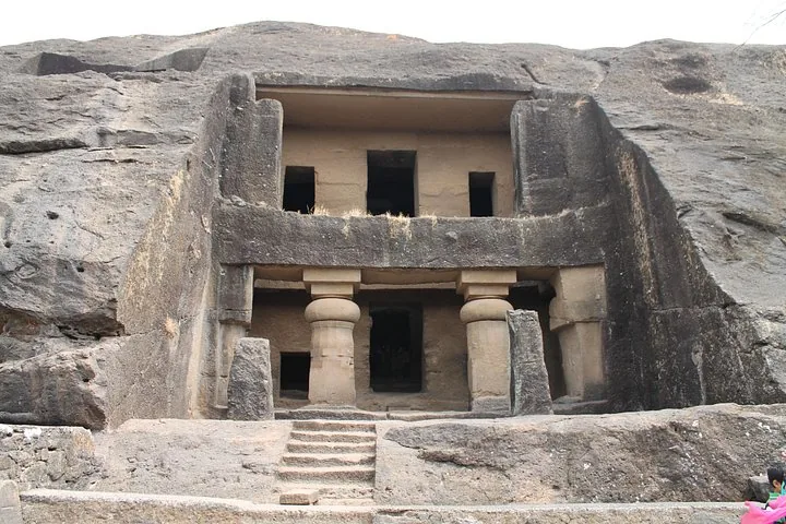 Exterior facade of an ancient two-story rock-cut cave
